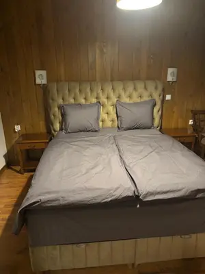 a large bed with a large headboard in a room at Katarino Mountain House in Razlog