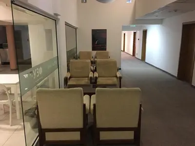 a waiting room with a row of chairs and a table at Hostel Elena in Sofia