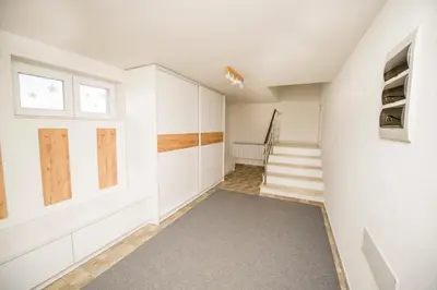 a hallway with white cabinets and stairs in a house at Villa Detelina in Sapareva Banya