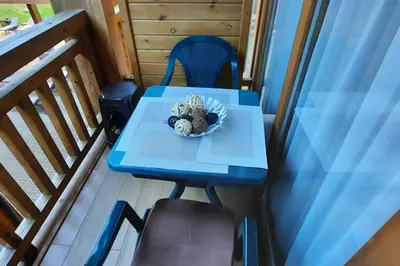 a blue table with a bowl of food on a balcony at Private Studio Pirin Golf Hotel Bansko in Razlog