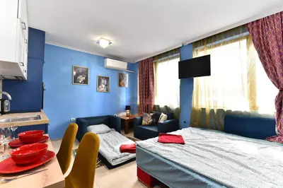 a blue room with a bed and a table and chairs at Bansko Studio 30m From Gondola - T.K. 4B in Bansko