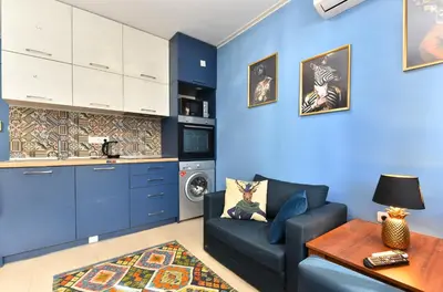 a blue living room with a couch and a table at Bansko Studio 30m From Gondola - T.K. 4B in Bansko