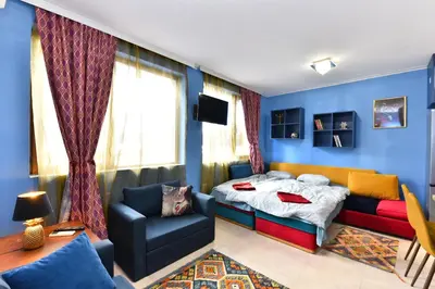 a bedroom with a bed and a couch at Bansko Studio 30m From Gondola - T.K. 4B in Bansko