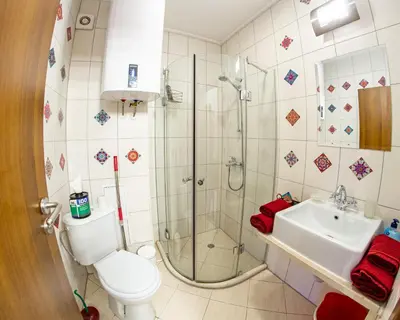 a bathroom with a shower and a toilet and a sink at Gondola 1 BDRM Flat in Cedar Lodge IV (D2) in Bansko