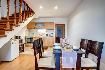 a kitchen and dining room with a table and chairs at MyPlace Pamporovo апартаменти за отдих in Pamporovo