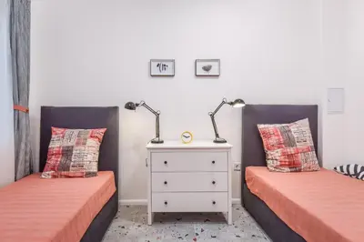 two beds in a room with two lamps on them at Cosy & renovated 2BD flat near Vitoshka by Flat Mаnager in Sofia