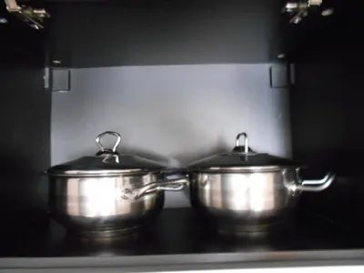 two metal pots sitting on top of a stove at Апартамент С-59 в Апарт-хотел Боровец Гардънс in Borovets
