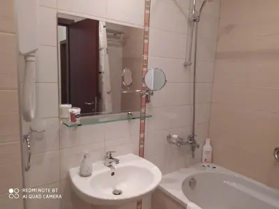 a bathroom with a sink and a tub and a mirror at Апартамент С-59 в Апарт-хотел Боровец Гардънс in Borovets