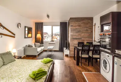a living room with a kitchen and a living room at Bansko Royal Towers Apartments - Gondola View in Bansko