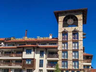 a building with a clock tower on top of it at Bansko Royal Towers Apartments - Gondola View in Bansko