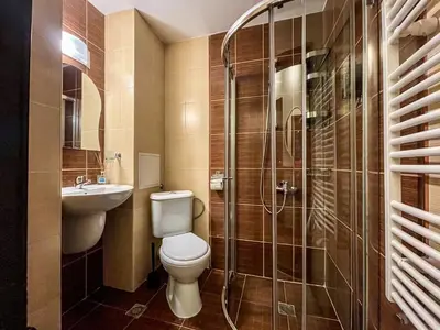 a bathroom with a toilet and a sink and a shower at Bansko Royal Towers Apartments - Gondola View in Bansko