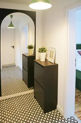 a hallway with two dressers and a mirror at Modern Cozy Apartment in Kyustendil