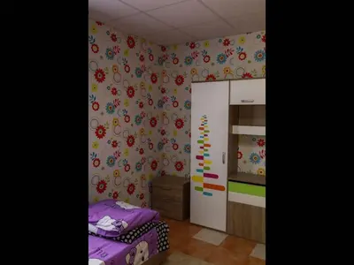 a bedroom with a bed and flowers on the wall at Nice bungalow in Petrich in Kamena