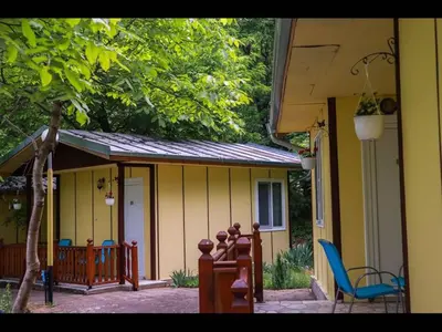 a porch with a blue chair and a house at Nice bungalow in Petrich in Kamena