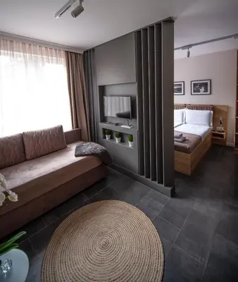 a hotel room with a couch and a bed at Borovete Mountain Luxury in Borovets