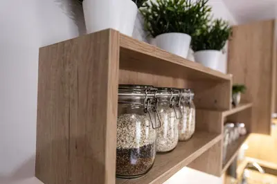 a row of glass jars on a shelf with plants at Borovete Mountain Luxury in Borovets