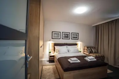a bedroom with a bed with two towels on it at Borovete Mountain Luxury in Borovets