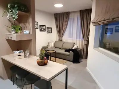 a living room with a table and a couch at Borovete Mountain Luxury in Borovets