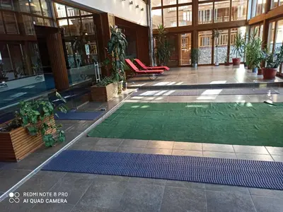 a lobby with a green rug in a building at Mountain view Private apartments in Pirin Golf and SPA resort in Razlog