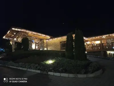 a building with lights in front of it at night at Mountain view Private apartments in Pirin Golf and SPA resort in Razlog