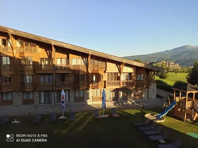 a resort building with a playground and a slide at Mountain view Private apartments in Pirin Golf and SPA resort in Razlog