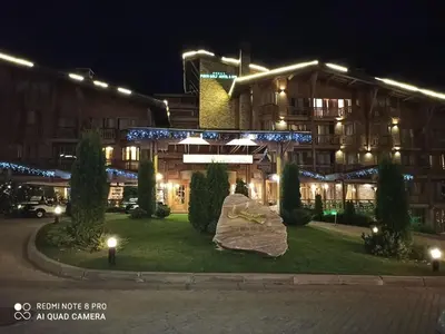 a hotel at night with a sculpture in front of it at Mountain view Private apartments in Pirin Golf and SPA resort in Razlog