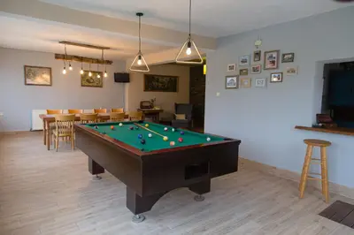 a living room with a pool table and a bar at къща Слави in Oreshak
