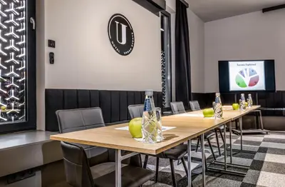 a conference room with a wooden table and chairs at Hotel Urban in Plovdiv
