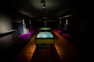 a dark room with a table and purple chairs at Hotel Urban in Plovdiv