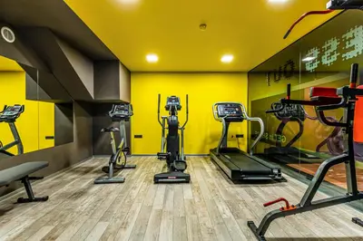 a gym with several tread machines in a room at Hotel Urban in Plovdiv