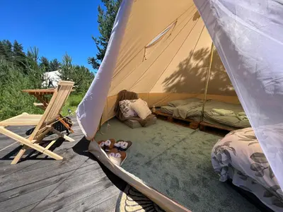 a woman sitting in a tent with teddy bears at Zarevo Glamping in Skobelevo