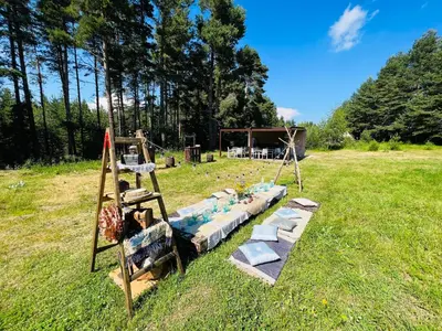 a bed in the grass in a field at Zarevo Glamping in Skobelevo
