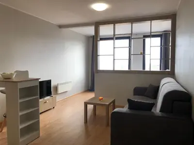 a living room with a couch and a tv at Aspen heights studio 308 in Razlog