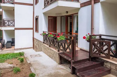 a balcony of a building with potted flowers on it at Луксозен апартамент - 