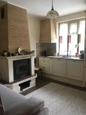 a kitchen with a fireplace and a sink and a stove at Willy Villy`s house in Chepelare