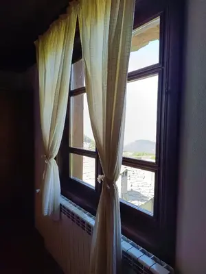 a window with white curtains in a room at LITTLE BIRD Residency - Luxury Guesthouses in Leshten in Leshten