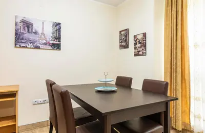 a dining room with a wooden table and chairs at 1BD apartment in a calm area near the centre by Flat Mаnager in Plovdiv