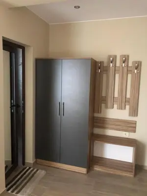 a large cabinet in a room next to a door at Стаи за гости Праматарови Огняново in Ognyanovo