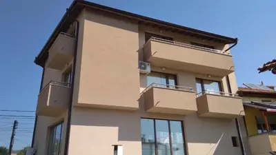 a building with balconies on the side of it at Стаи за гости Праматарови Огняново in Ognyanovo