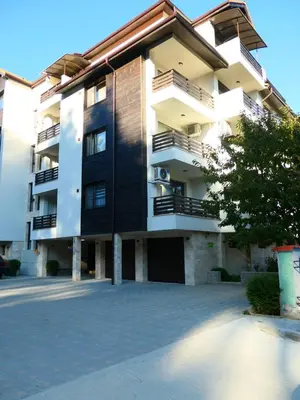 a large apartment building with a parking lot at Nikol Deluxe in Velingrad