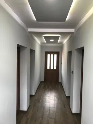 an empty hallway with white walls and a door at Sharkov Guest House in Dolen
