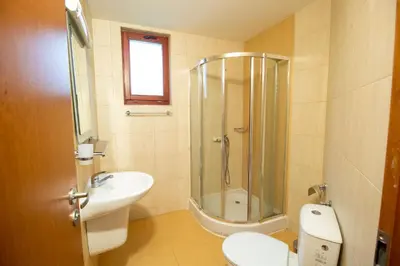 a bathroom with a shower and a toilet and a sink at 2 bedroom, 2 showeroom Villa suitable for a family skication and remote working in Pamporovo