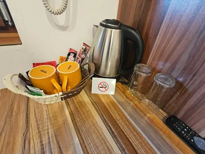 a counter with two cups and a coffee pot on it at Емили Фемили Хаус in Koprivshtitsa