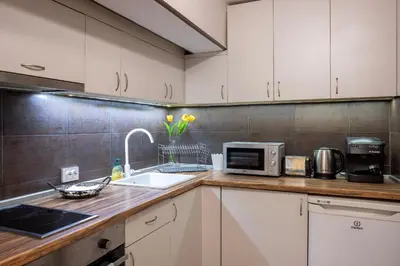 a kitchen with white cabinets and a sink and a microwave at Central & Beautiful Apartment - Perfect Location by Flat Mаnager in Sofia