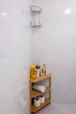 a bathroom with a shelf with towels and a basket at Central & Beautiful Apartment - Perfect Location by Flat Mаnager in Sofia
