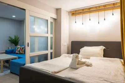 a child laying on a bed in a bedroom at Central & Beautiful Apartment - Perfect Location by Flat Mаnager in Sofia