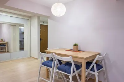 a dining room with a wooden table and four chairs at Central & Beautiful Apartment - Perfect Location by Flat Mаnager in Sofia