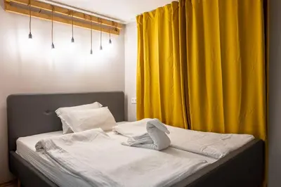 a bedroom with a bed with a yellow curtain at Central & Beautiful Apartment - Perfect Location by Flat Mаnager in Sofia