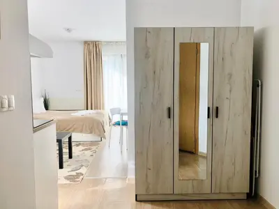 a wooden door in a room with a bedroom at Temerso Studio-Apartment in Bansko