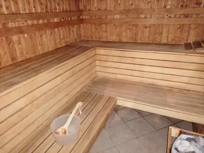 a wooden sauna with a bucket in the middle at Aspen Golf - private apartments in Razlog
